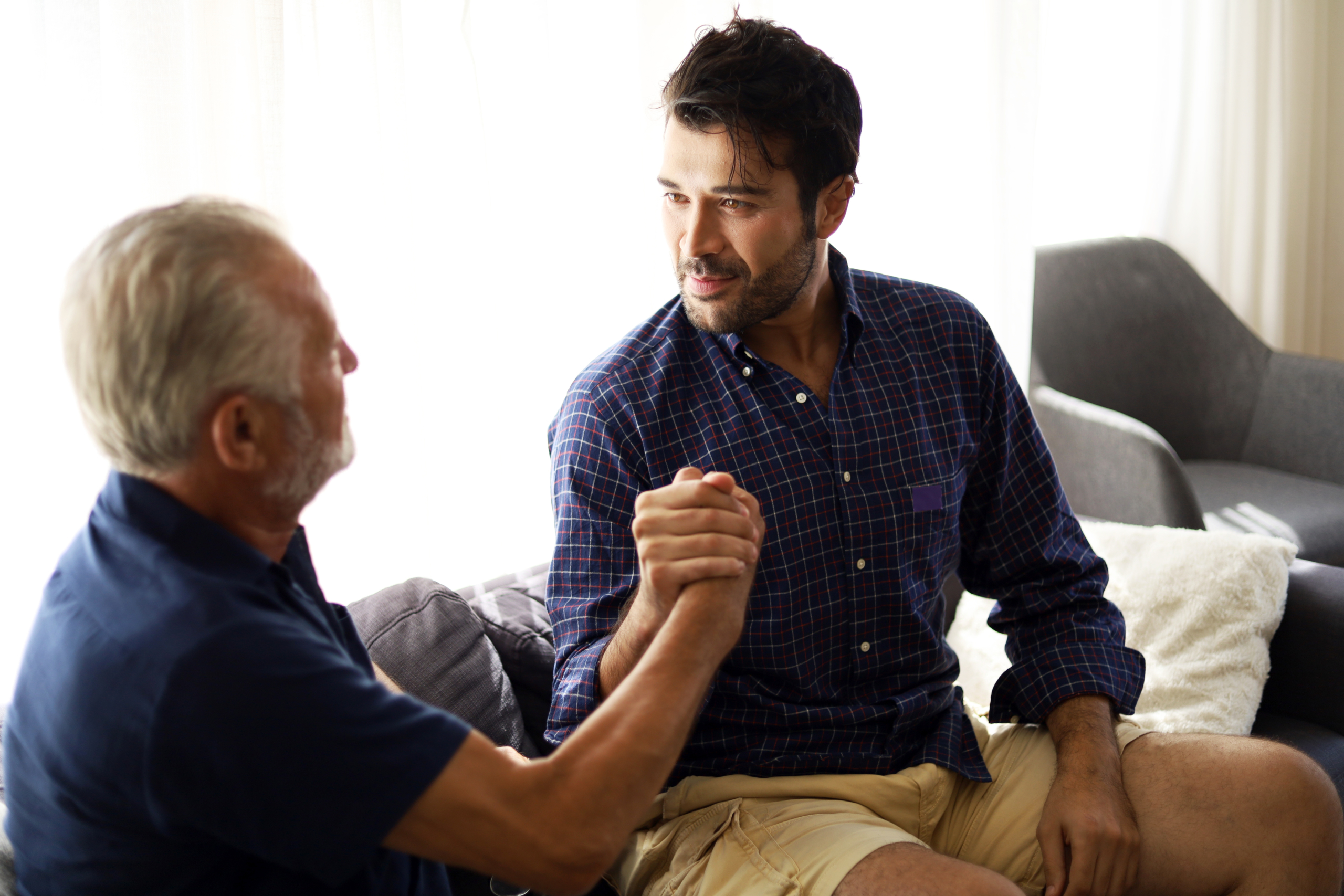 Happiness father and son talking and sharing discussion lifestyle for domestic life protection from COVID-19 virus at home.